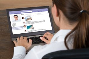Businesswoman Chatting On Social Website With Laptop