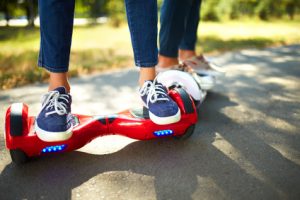 young man and woman riding on the Hoverboard in the park. content technologies. a new movement. Close Up of Dual Wheel Self Balancing Electric Skateboard Smart. on electrical scooter outdoors